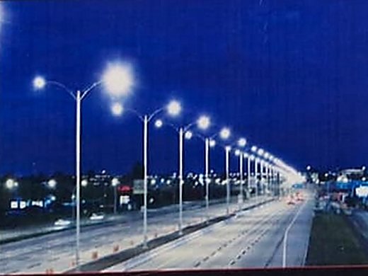 A highway lit by street lighting at night