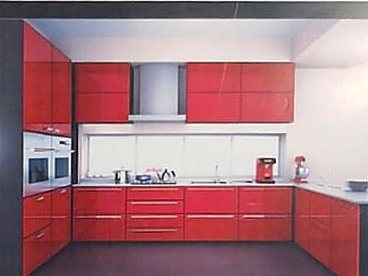 A fitted modular kitchen in red and white